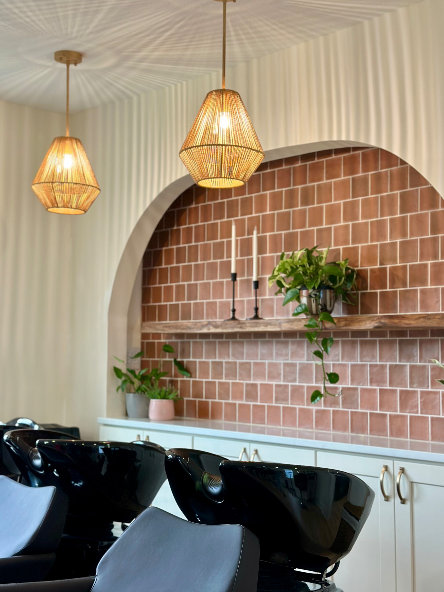 Mill & Mane Hair Co. salon interior with terracotta tile and arched mirror